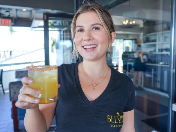 Photo of Beeside Balcony Del Mar employee holding a signature craft cocktail